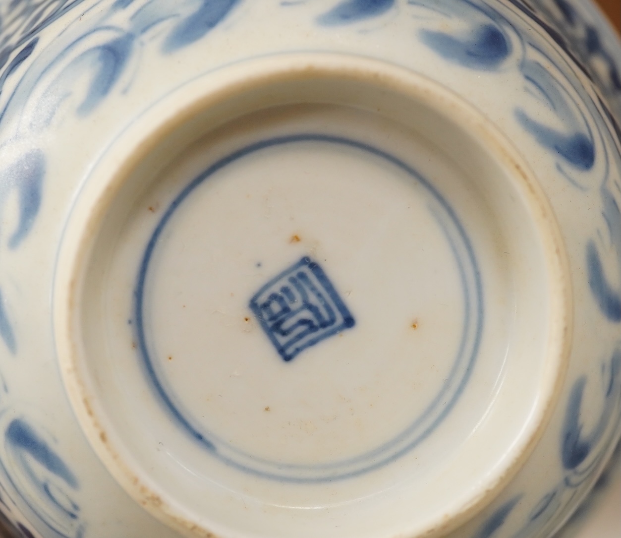 A Chinese blue and white bowl, Kangxi, 15cm. diam., a famille rose teapot stand, Yongzheng, and two doucai bowls. Condition - varies